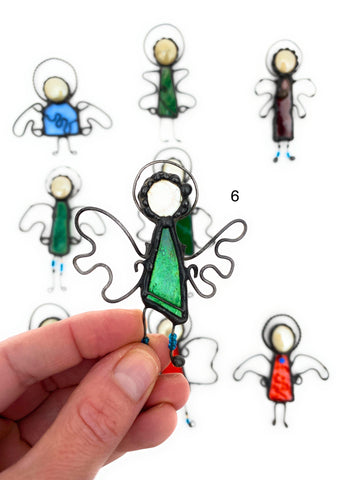 Blissful Angel stained glass suncatcher by LeKoky, created by artist Lenka in Southampton, Hampshire UK. The suncatcher features a unique and stunning design with high-quality coloured glass and tinned copper wire, measuring approximately H 7 cm x W 6 cm. Can be hung on a Christmas tree, in a window, or on a wall for a beautiful decorative touch.