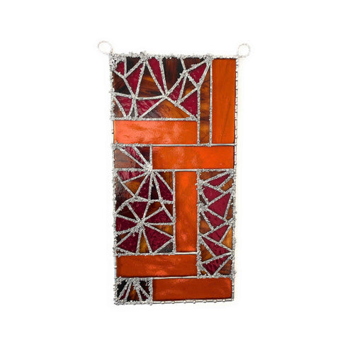 Handcrafted stained glass panel by Lekoky, featuring shades of orange, mauve and red. Created by artist Lenka in Southampton.