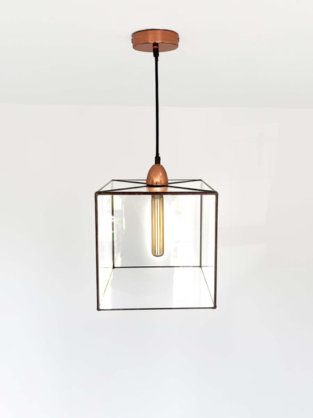 A stunning handcrafted cube chandelier, inspired by platonic solids and created by glass artist Lenka in Southampton, is pictured. The LeKoky brand offers a range of platonic solid shapes, including this chandelier available in four sizes and four patinas applied on soldering work. Height adjustable and fitted with a ceiling cup, this chandelier is made to order individually and dispatched within 3 working weeks. Bulb not included. Perfect for elevating any home decor.
