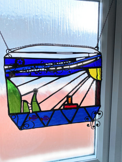 Close-up view of the ocean-themed stained glass suncatcher showing intricate craftsmanship.